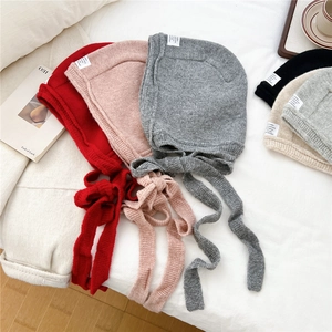 Winter knitted earflap hat for women with tie straps and decorative label in five colors