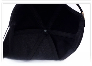 Internal view of black baseball cap showing six-panel stitching and reinforced seams