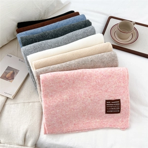 Solid color thick knitted winter scarf for women in soft wool-like texture with ribbed edges
