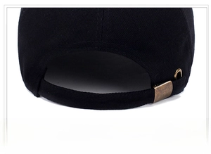 Detailed close-up of cotton baseball cap with adjustable bronze metal buckle strap
