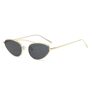 Cat eye sunglasses with gold metal frame and double bridge structure on white background