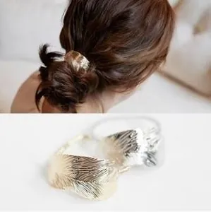 Detailed view of alloy feather hair clips in gold and silver showing realistic textures