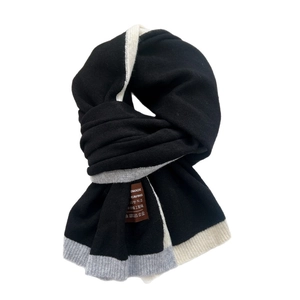 Minimalist knit scarf in black with grey and white stripes and handmade woven label