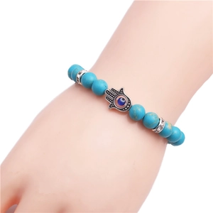 Turquoise beaded Hamsa hand bracelet with blue evil eye pendant and silver accents