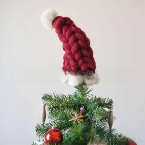 Close-up of red and white knitted Christmas hat used as a festive tree topper ornament