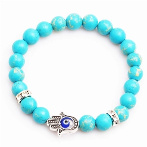 Blue turquoise beaded bracelet with Hamsa Hand and Evil Eye charm on white background