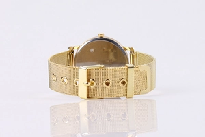 Detail view of gold Milanese mesh watch strap with metal pin buckle and five adjustment holes