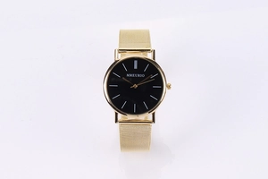 Detail of the Milanese gold mesh strap and black dial on this minimalist quartz watch
