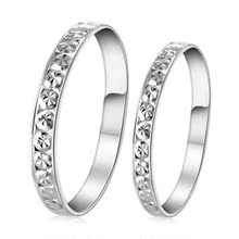 Close-up of silver-tone faceted textured rings set for couples on a white background