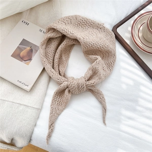 Detailed close-up of oatmeal pointelle knit scarf showing hollow texture and soft material