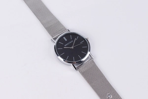 Close-up of silver Milanese mesh band and minimalist black dial on quartz watch