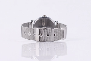 Detailed macro shot of silver stainless steel mesh strap with adjustable buckle