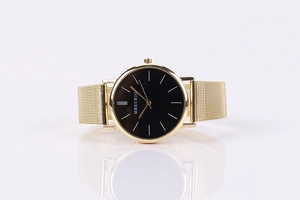 Detail view of MREURIO minimalist quartz watch with black dial and gold Milanese mesh strap