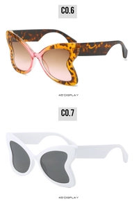 Detail view of leopard print and white butterfly sunglasses with gradient lenses