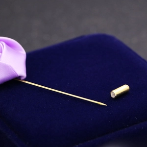 Elegant gold long pin brooch featuring a handmade purple ribbon flower on velvet box