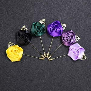 Detailed fan-shaped layout of fabric rose brooches in six elegant colors with gold pins