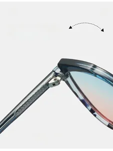 Macro view of durable metal hinge on translucent cat-eye sunglasses with gradient lenses