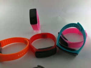 Gros plan de bracelets de sport en silicone coloré en rose orange rouge et bleu