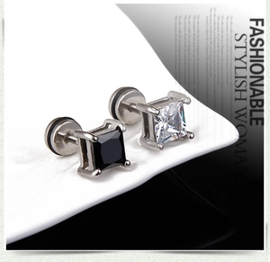 Macro shot of square-cut black and white zircon earrings with polished titanium steel studs