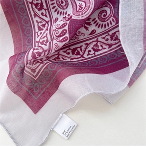 Detail of paisley square scarf showing twill texture and 10% cotton fabric composition