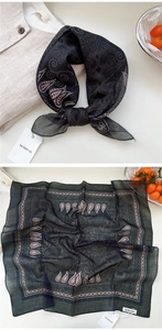 Detail of grey paisley cotton linen scarf with soft texture and chic pattern design