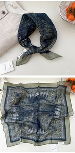 Detailed view of dark blue paisley silk scarf with vintage bohemian prints and fringe