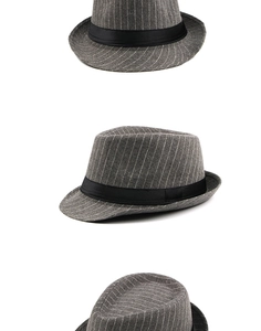 Macro shot of grey striped wool texture and black satin ribbon on a trilby jazz hat