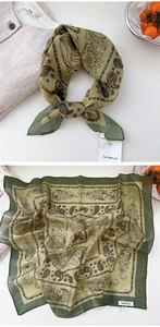 Detail of green paisley square scarf with cotton linen textures and floral pattern