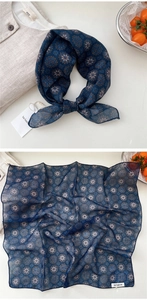 Detail of square navy blue cotton scarf with vintage mandala pattern and soft texture