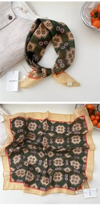 Detailed close-up of a vintage emerald green square scarf with floral geometric patterns