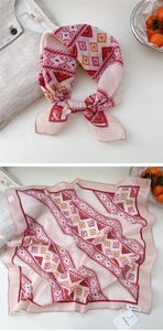 Detail view of pink geometric print scarf tied as a necktie and flat-laid display