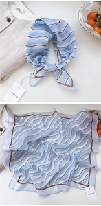 Detail showing soft blue cotton-linen neck scarf with wave patterns and stitched edges