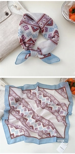 Detail view of square scarf showing geometric diamond pattern and light blue edges