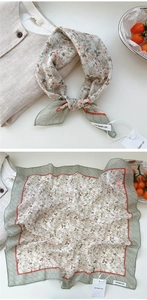 Detailed view of floral cotton neck scarf with green scalloped edges and pink blossoms