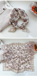Detail of floral cotton linen scarf with vintage pattern and plaid border textures