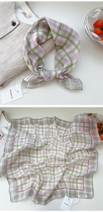 Detailed macro view of soft cotton linen floral plaid scarf with delicate stitching