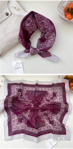 Detail of burgundy paisley cotton linen scarf showing intricate patterns and soft texture