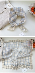 Close-up of cotton-linen square scarf with blue and yellow plaid pattern and neat stitching