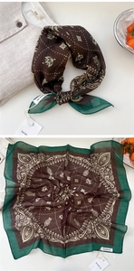 Macro view of paisley print cotton linen scarf with contrast borders and stitching