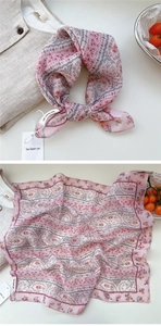 Detailed view of floral pink cotton neck scarf with delicate paisley pattern and tag