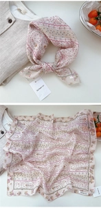 Detail of soft floral cotton linen square scarf showing pattern texture and knotted style