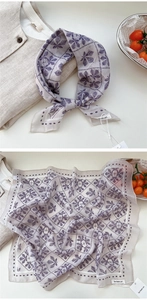 Detail of light purple floral cotton scarf with leaf patterns and soft mesh texture