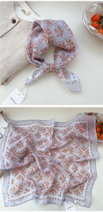 Detail of light purple cotton linen floral scarf with red-brown leaf patterns and checks