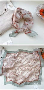 Close-up of geometric floral cotton linen scarf with soft roll hem and boho pattern print