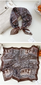 Close-up of brown paisley floral square scarf showing texture and hem details