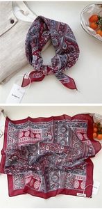 Detail view of burgundy paisley cotton linen scarf with elegant floral patterns