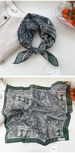 Macro view of green floral cotton linen square scarf with paisley patterns and soft texture