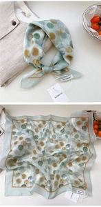 Detail of light green floral square scarf with irregular polka dots and rolled edges
