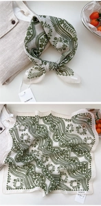 Close-up of lightweight cotton-linen floral square scarf with green paisley patterns