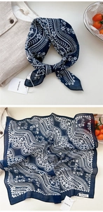 Close-up of dark blue floral square scarf with paisley patterns and soft cotton texture